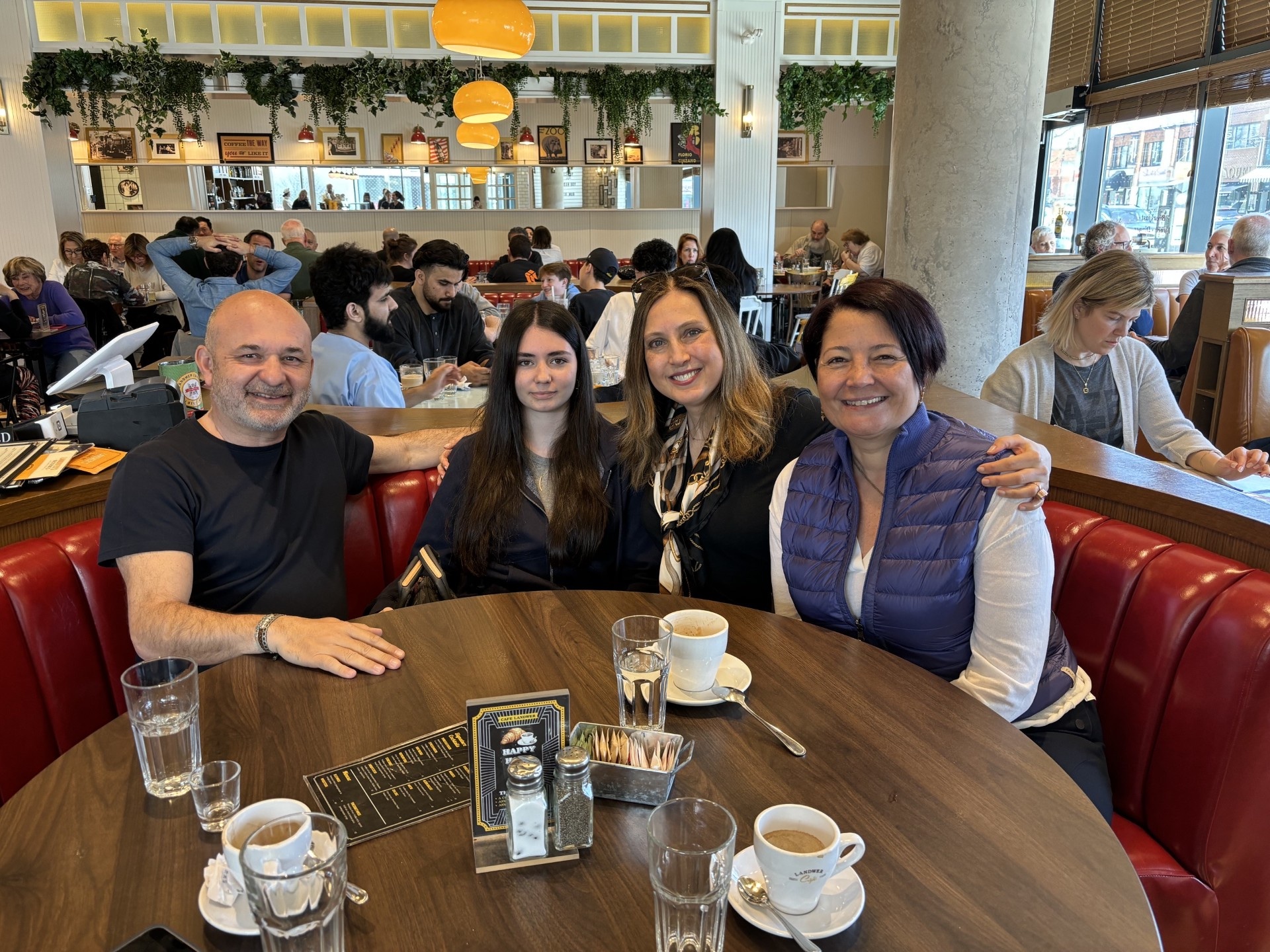 Filiz with a family at a café table