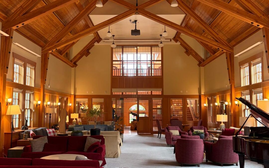 The student lounge at Shawnigan Lake School, a timber-framed hall with vaulted cedar ceiling, armchairs, sofas and a grand piano